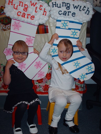 Two children with signs saying hung with care